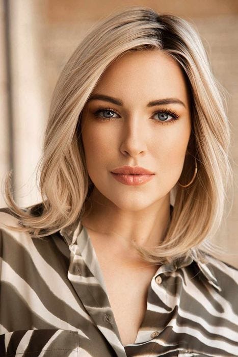 Woman in a past the shoulders light blonde straight lace front wig