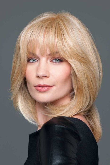Woman in a warm blonde wiglet hair topper on the crown area