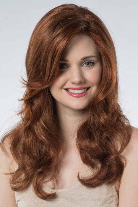 Woman in an extra long medium auburn curly lace front wig