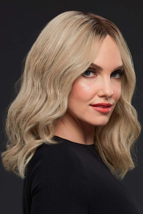 Woman in a past-the-shoulders, light ash blonde, wavy lace front wig