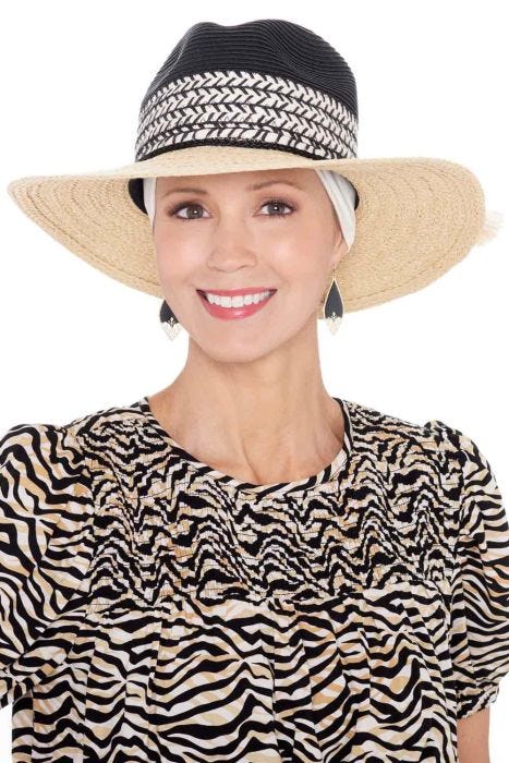 Woman in 2 tone summer fedora hat with brim, with headband underneath for cancer patients