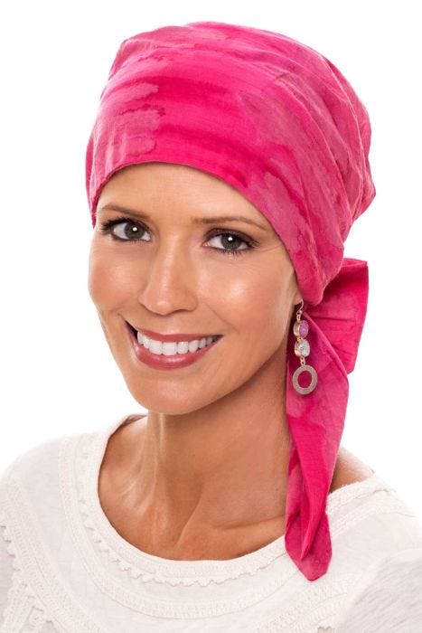 Woman in pink cotton tie dyed head wrap for women with cancer