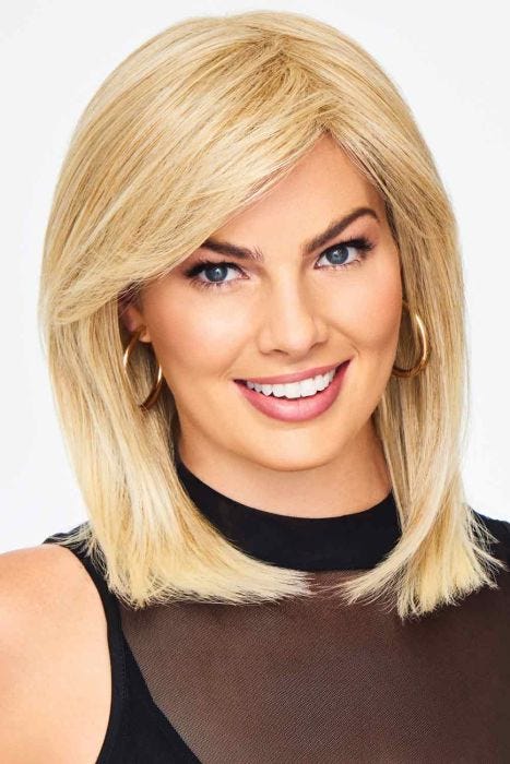 Woman in a past the shoulder straight pale blonde wig with side bangs