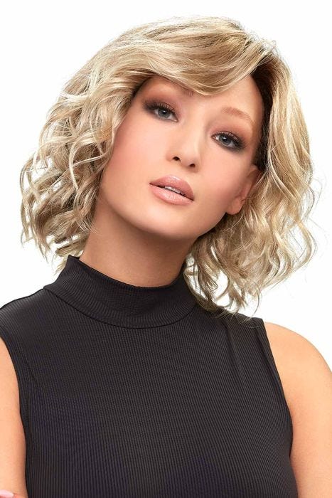Woman in a shoulder length light blonde curly lace front wig