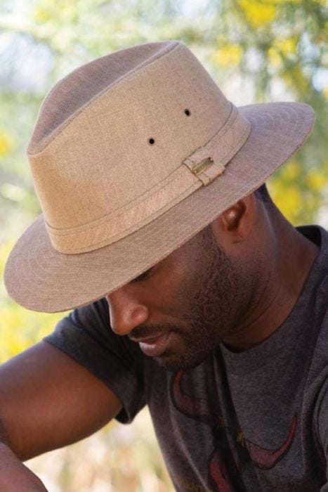 Cool guy outdoors in brimmed toyo beige men's safari hat for sun protection