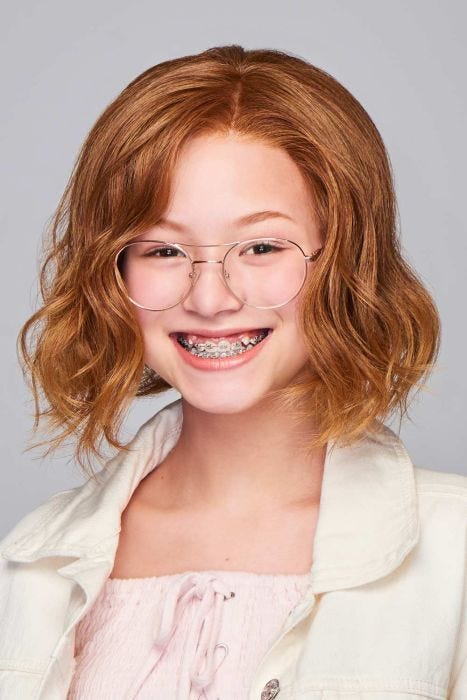 Young girl in a past the chin wavy medium red lace front children's wig
