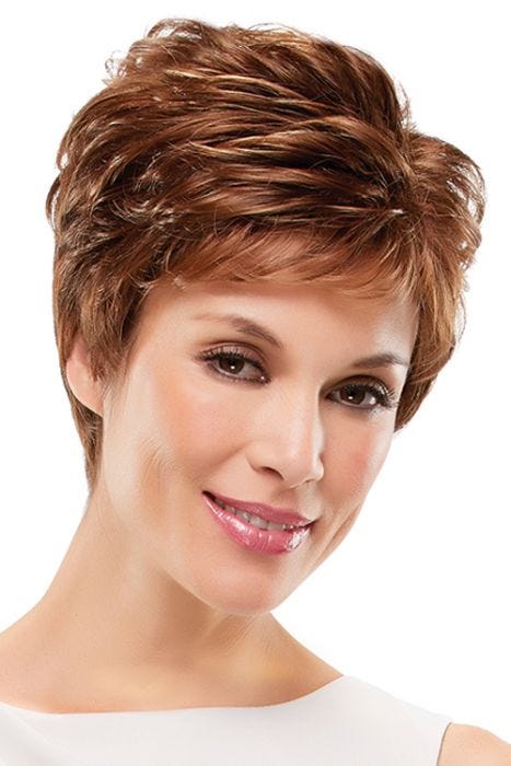 Woman in an auburn pixie wig with feathered layers and short fringe bangs