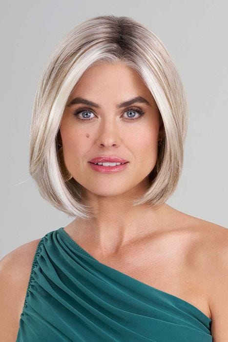 Woman in a shoulder length light blonde lace front bob wig with curled under ends and dark roots