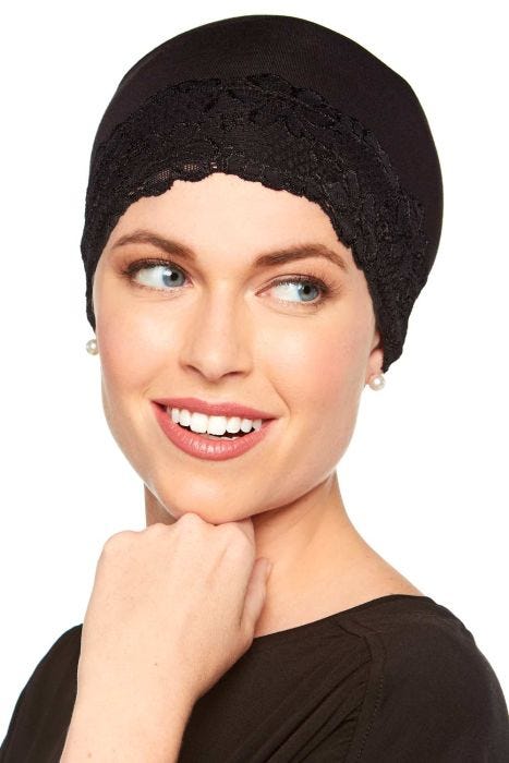 Woman in black bamboo lace trimmed sleeping cap or hat liner for women with cancer or hair loss