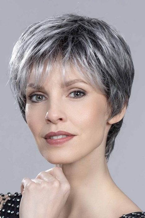 Woman in an edgy light blonde layered lace front pixie wig with bangs