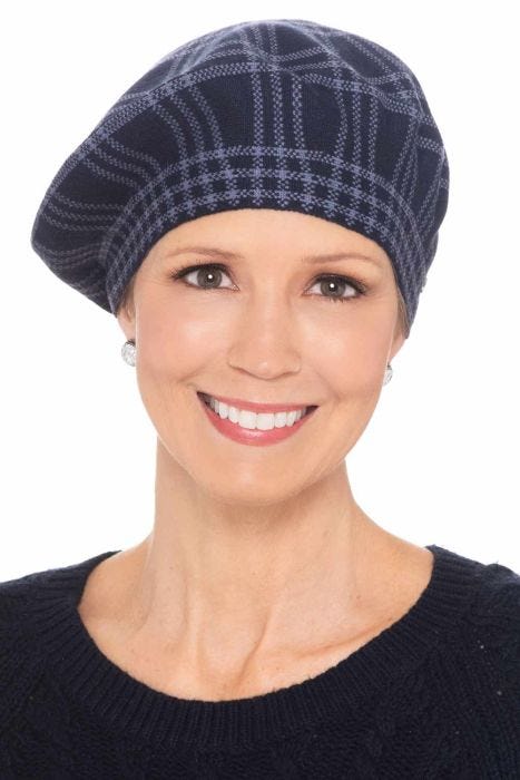 Woman in blue plaid winter beret hat