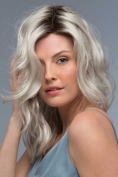 Woman in a past the shoulders curly platinum blonde lace front wig