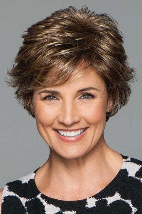 Woman in a petite medium brown short layered pixie bob wig with side fringe bangs