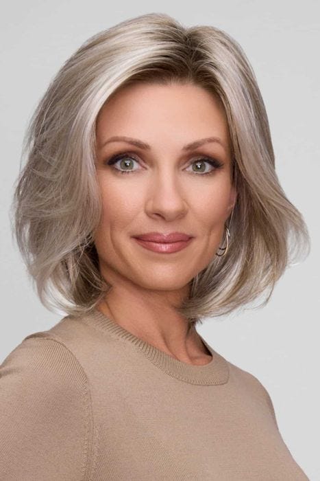 Woman in a petite shoulder length light brown lace front bob wig