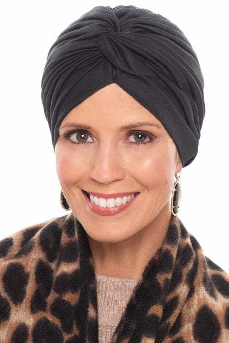 Woman in black vintage style pleated turban for women with cancer