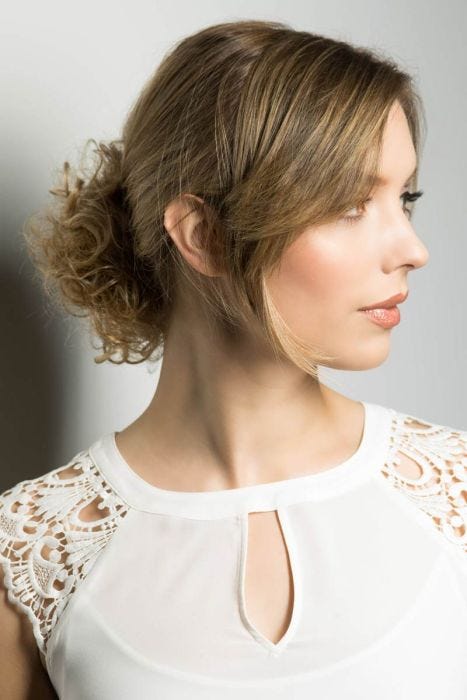 Woman in a light auburn curly hair scrunchie