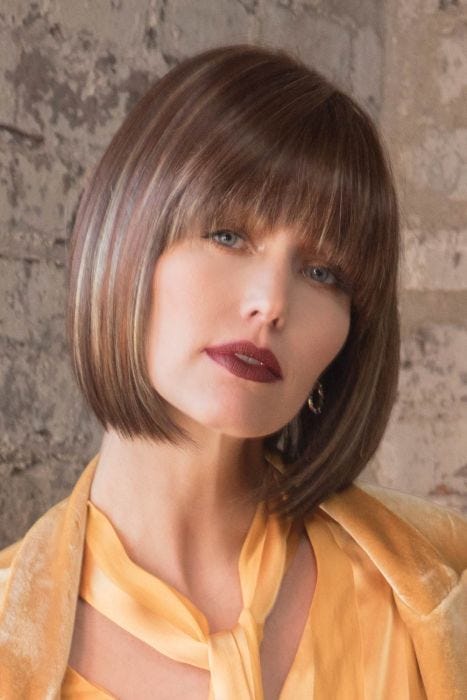 Woman in brown blunt cut bob wig with bangs
