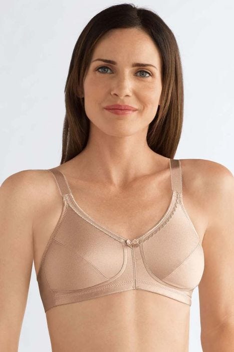 Woman in a smooth pocketed nude colored mastectomy bra