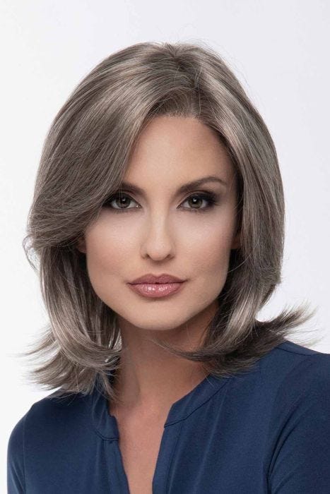 Woman in a shoulder length grey lace front wig with long layers
