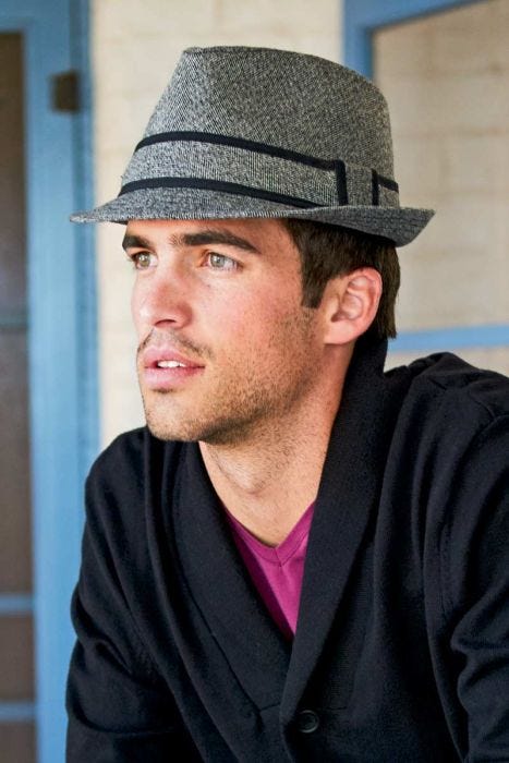 Man outdoors in narrow brimmed winter tweed fedora hat for men