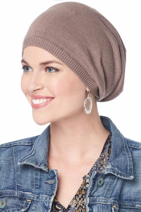 Woman in thinly knit taupe slouchy chemo beanie hat