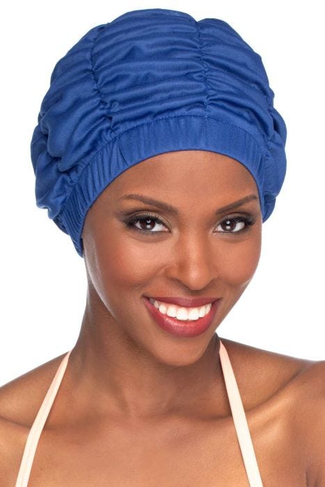 Woman in white shirred shower cap or swimming cap