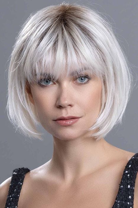Woman in a chin length silver lace front rounded bob with fringe bangs