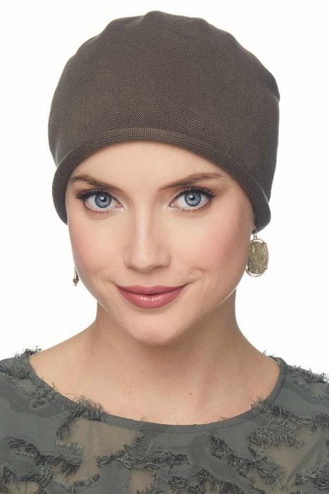 Woman in neutral knitted cotton beanie hat for cancer patients