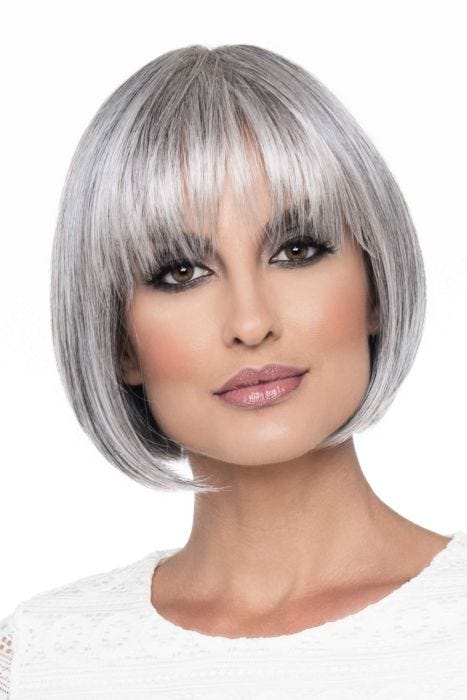 Woman in a blunt chin length grey wig with fringe bangs