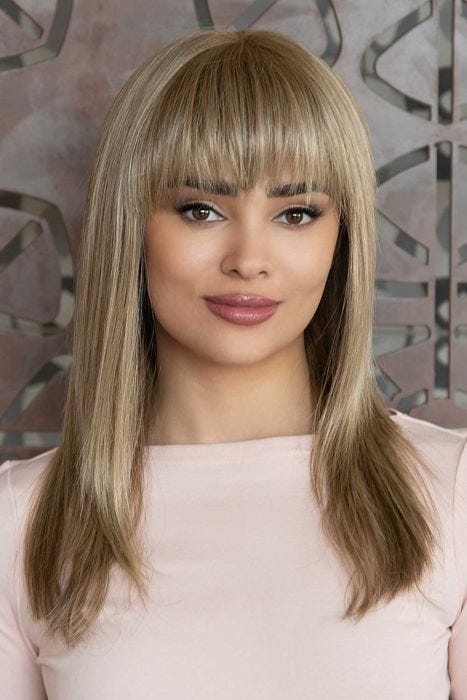 Woman in an extra long straight medium brown human hair wig with blunt bangs