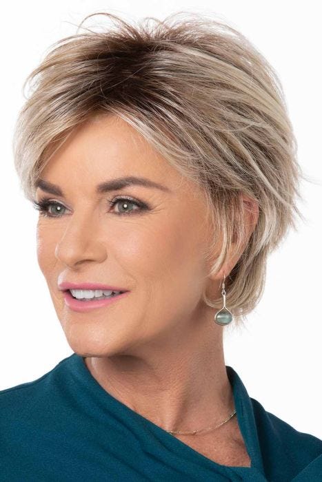 Woman in a large light blonde long pixie wig with side bangs