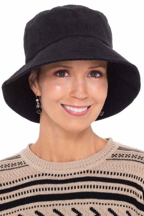 Woman in black corduroy winter bucket hat for cancer patients