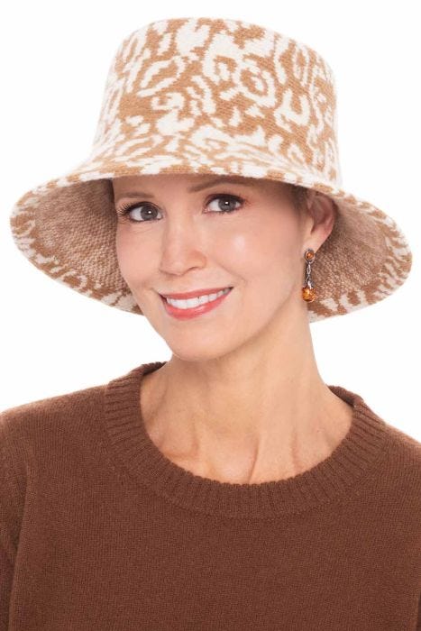 Woman in grey and white leopard print winter cloche or bucket hat for women