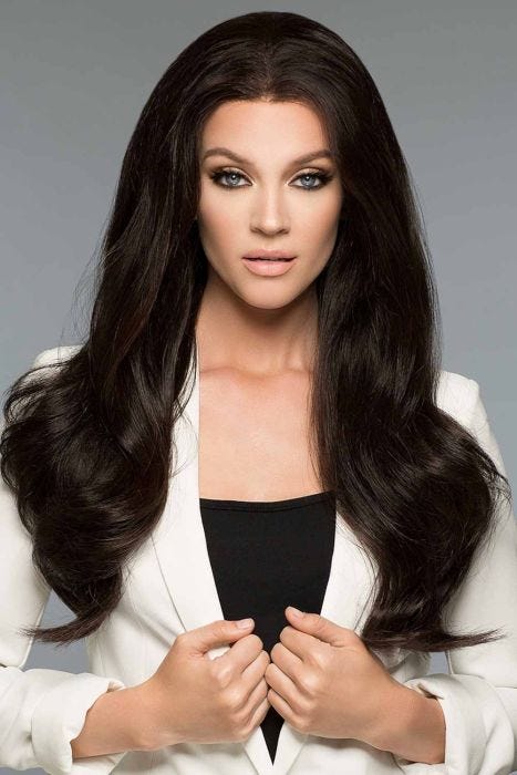 Woman in an extra long black wavy human hair wig