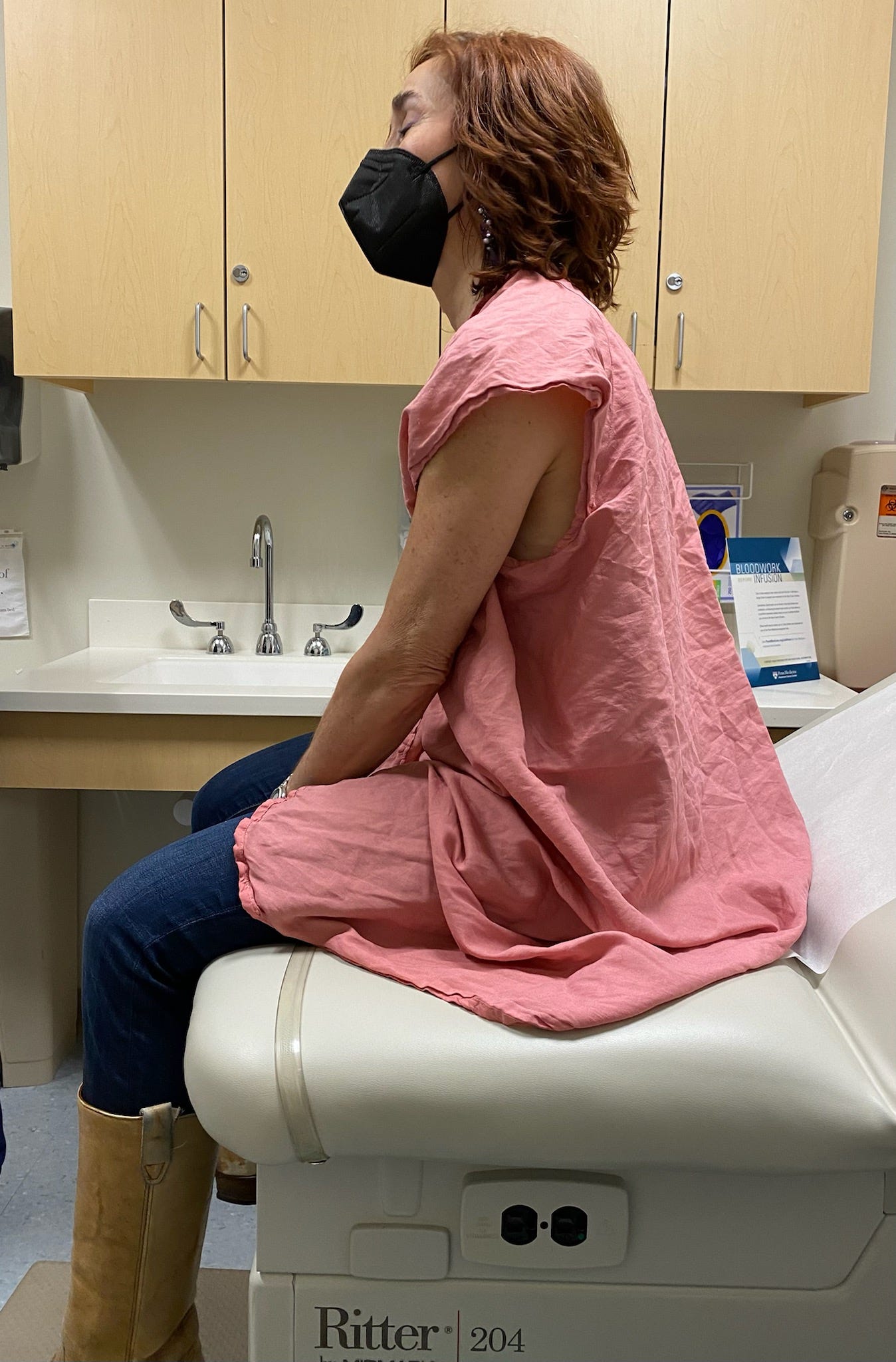 Women in a doctors office going through chemotherapy cancer treatment showing off her mid-length hairdo